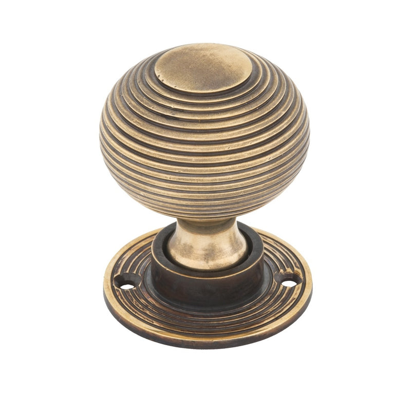 From The Anvil Beehive Knob Handles on Round Rose - Aged Brass